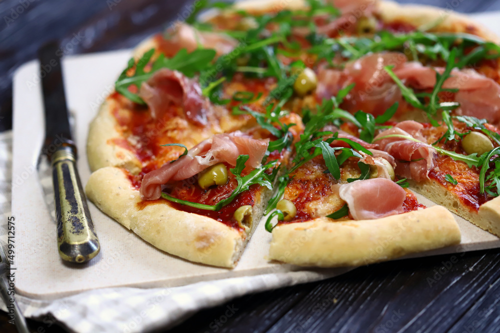 Italian pizza with jamon and arugula. Homemade pizza. Italian pizza with jamon and arugula. Homemade pizza.