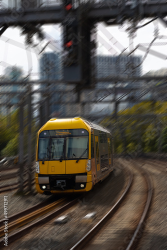 Commuter train approaching at a train station in Sydney NSW Australia blurred background 