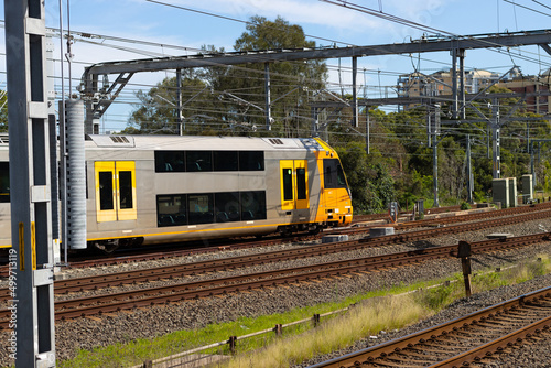 Commuter train approaching at a train station in Sydney NSW Australia blurred background 