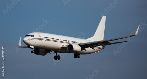 Image of passenger plane landing in airport afternoon at sunny day