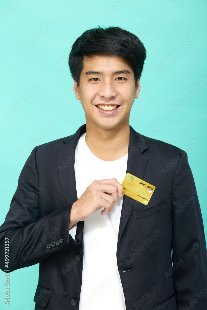 Young business man holding yellow credit card Young business man holding yellow credit card