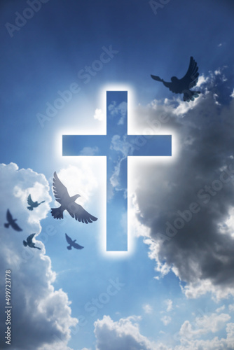 Cuadro en lienzo Glowing cross and drawn doves in blue cloudy sky