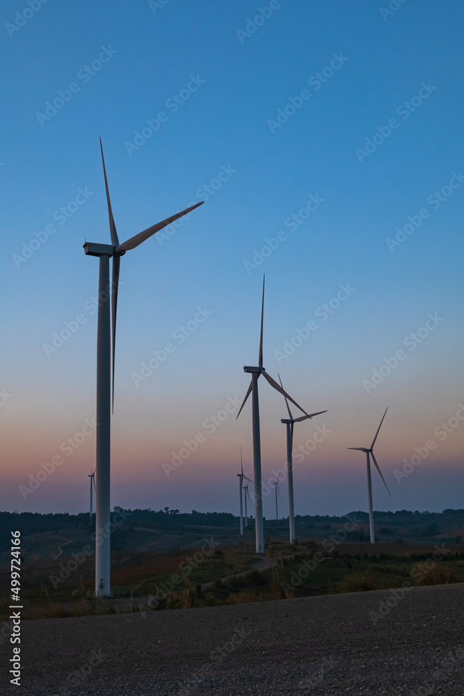 Obraz premium Wind turbines on mountain landscape. Road through mountains wind farm eco. Green ecological power energy concept.