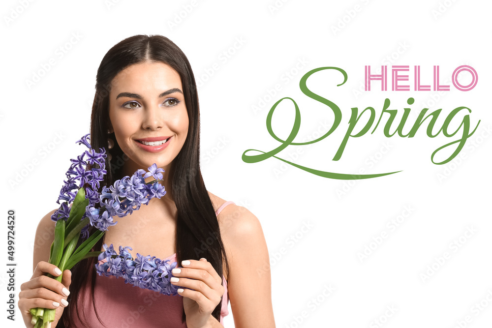 Beautiful young woman with hyacinth flowers and text HELLO SPRING on white background Beautiful young woman with hyacinth flowers and text HELLO SPRING on white background