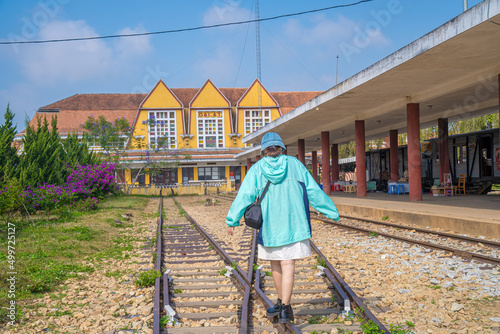 Focus young girl walking in Ancient railway station. This is famous place, history destination for traveler, french architecture antique train tranport tourist to visit in Da lat, Vietnam photo