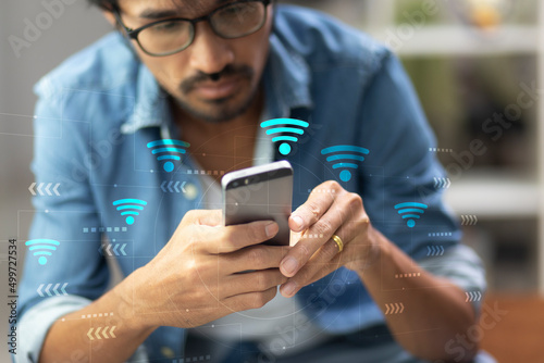 man using mobile phone and open internet wifi setting while sitting at home,  internet wifi concept photo