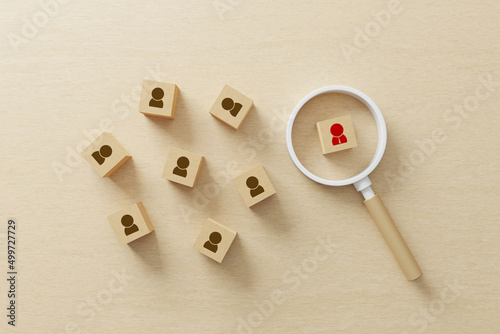 Human resource and talent management and recruitment business building team, Personal development of employee in organization. Wood cube block on wooden table with magnifying glass. 3d illustration