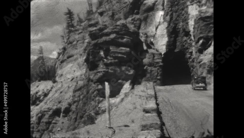 West Tunnel at Glacier National Park 1936 - Cars drive through the West Tunnel on Going-to-the-Sun Road in Glacier National Park in 1936. photo