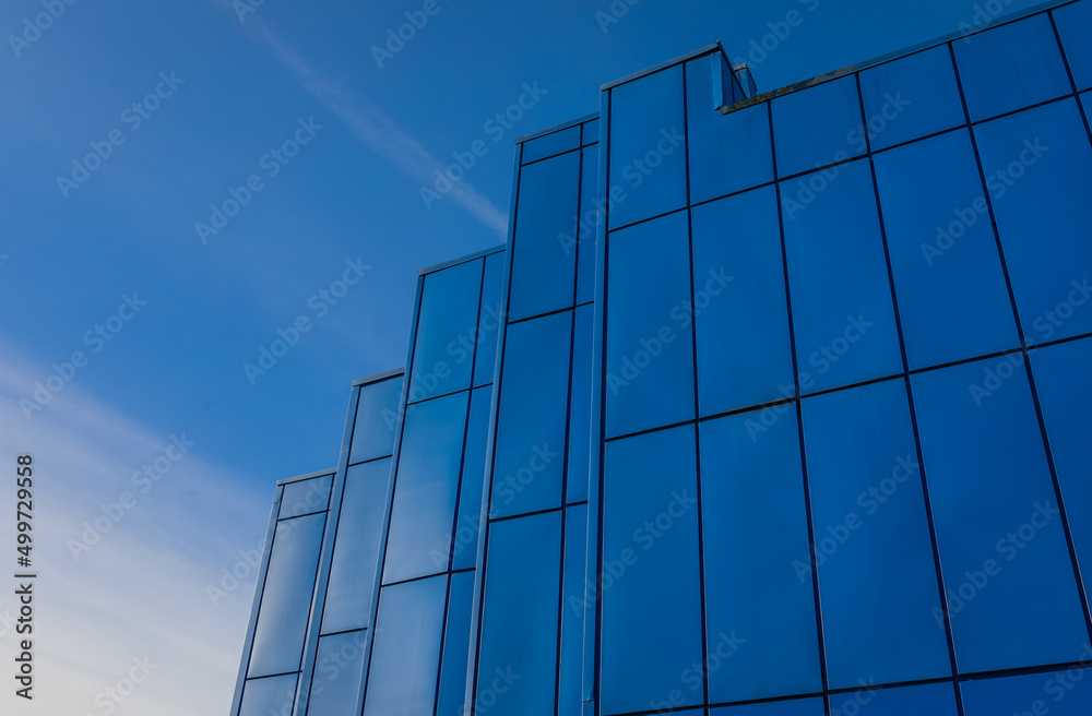 Modern office building against blue sky in early morning