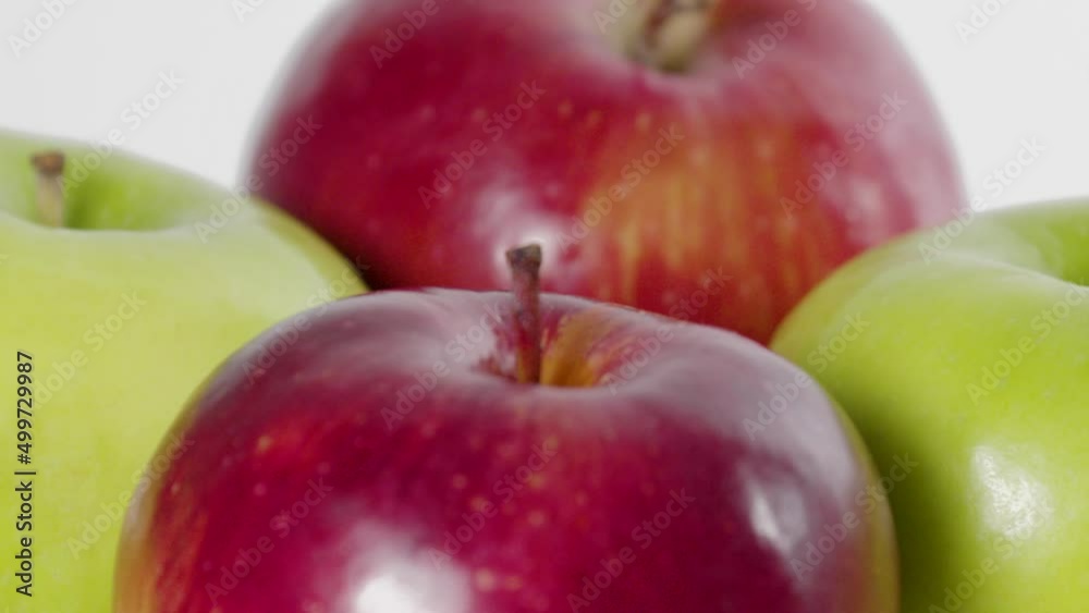 mix of very fresh red and green apples rotating 360 grades on white background mix of very fresh red and green apples rotating 360 grades on white background