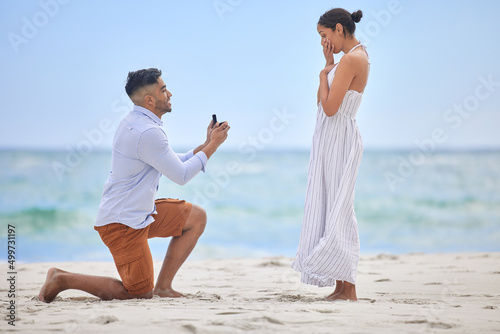 You make me the happiest Ive ever been. Shot of a young man proposing to his girlfriend on the beach.