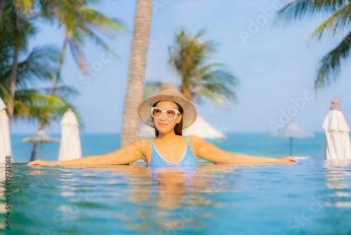 Portrait beautiful young asian woman relax smile enjoy leisure around swimming pool