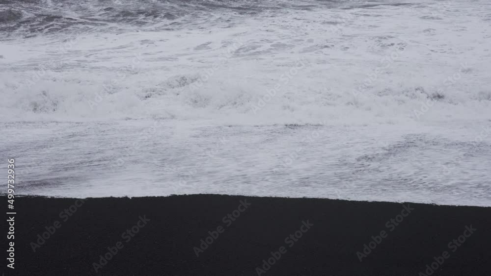 White Surf On Black Sand Beach