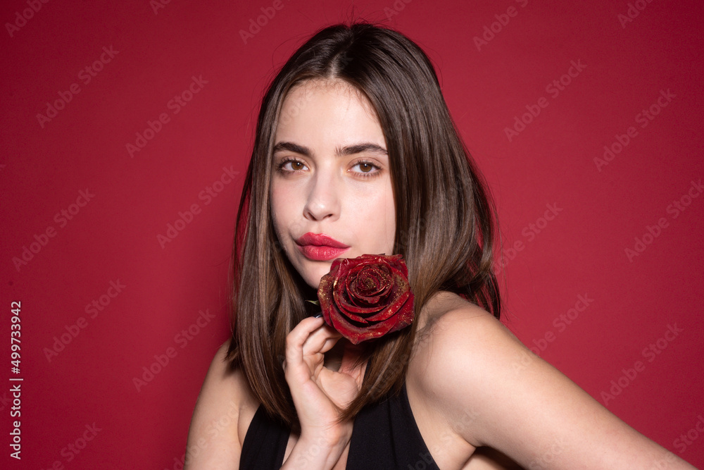 Close-up portrait of young beautiful sexy woman with red rose near face. Vogue spring summer style. Perfume cosmetics concept. Nofilter unaltered skin. Natural skin texture. Close-up portrait of young beautiful sexy woman with red rose near face. Vogue spring summer style. Perfume cosmetics concept. Nofilter unaltered skin. Natural skin texture.