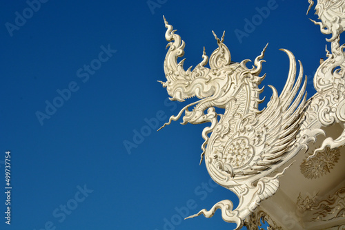 white carved serpent on blue sky background
