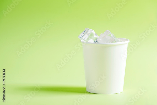 White plastic cup with ice cubes