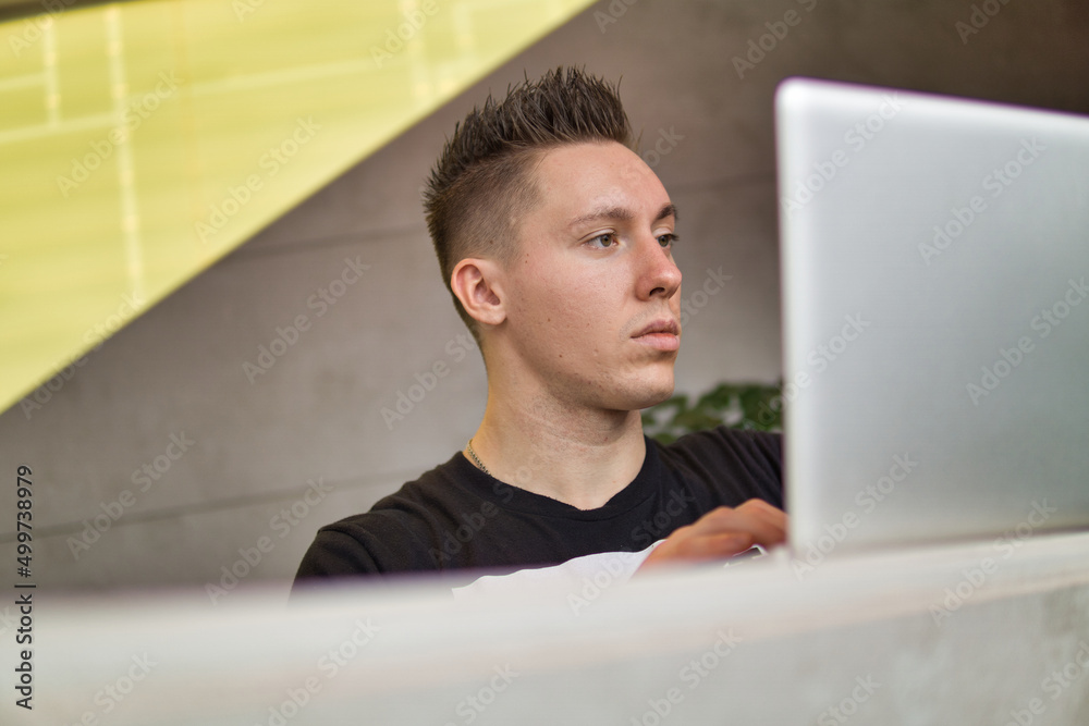 Young man using laptop indoor. Young man using laptop indoor.