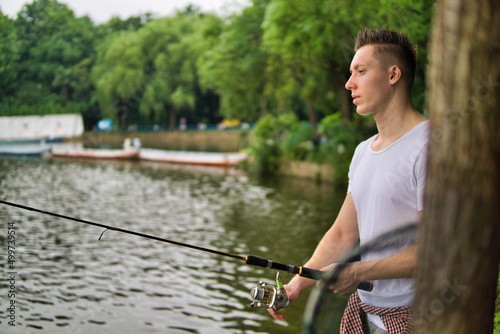Young man fishing on a lake.