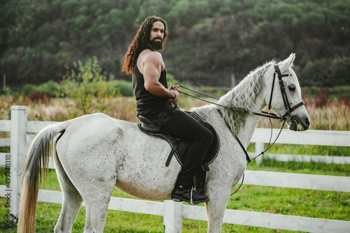 Sexy farmer man horse riding. Muscular cowboy on horseback. © Volodymyr