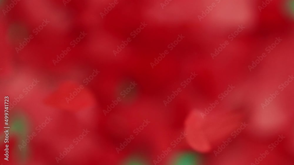 Red paper confetti hearts flying on chroma key green screen background Red paper confetti hearts flying on chroma key green screen background