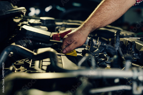 Car mechanic checking oil level in a mechanical workshop © zorandim75