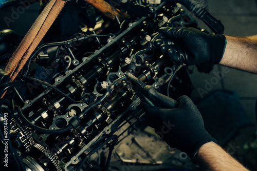 Auto mechanic working and repair on car engine in mechanics garage
