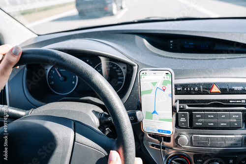 Gps navigation map system. Global positioning system on smartphone screen in auto car on travel road. GPS device satellite system technology. © Maksym