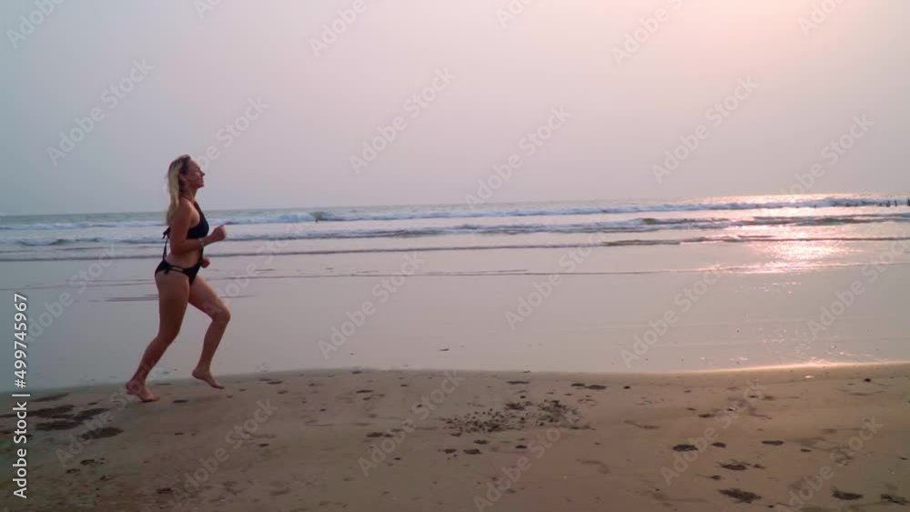 Running health benefits. The girl runs along the sandy beach. Running health benefits. The girl runs along the sandy beach.