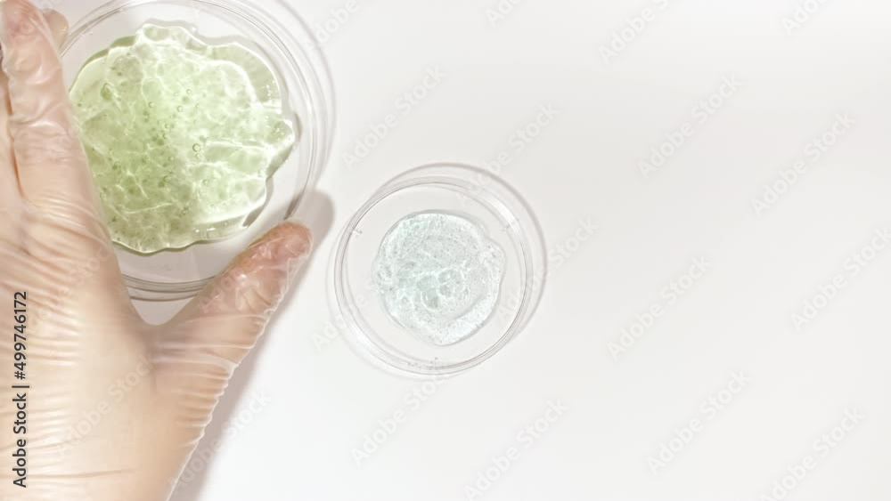 Petri dishes with cosmetics samples on a white background. Transparent Gel Fluid, Serum, Cream, hyalurinic acid with Bubbles. Chemical laboratory research. Natural Organic cosmetics, medicine. 4k Petri dishes with cosmetics samples on a white background. Transparent Gel Fluid, Serum, Cream, hyalurinic acid with Bubbles. Chemical laboratory research. Natural Organic cosmetics, medicine. 4k