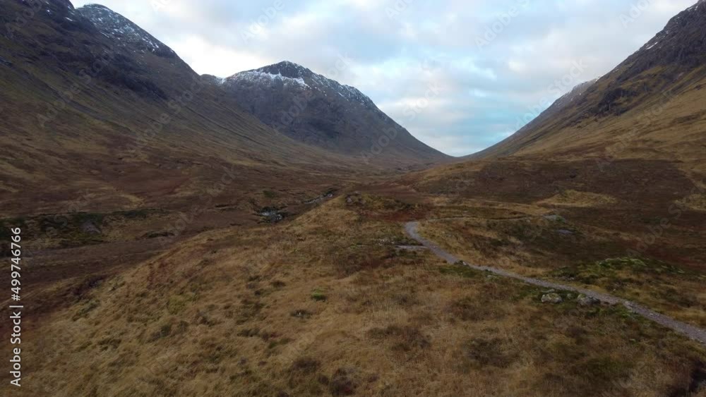 Low level aerial shot of the valley bottom of the hills and mountains at Glencoe, Scotland in Great Britain Low level aerial shot of the valley bottom of the hills and mountains at Glencoe, Scotland in Great Britain