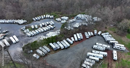 Travel trailer recreational vehicle, RV mobile home parking campground site. Aerial view among forest trees.