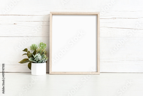 Mockup of a vertical wooden frame on a light background