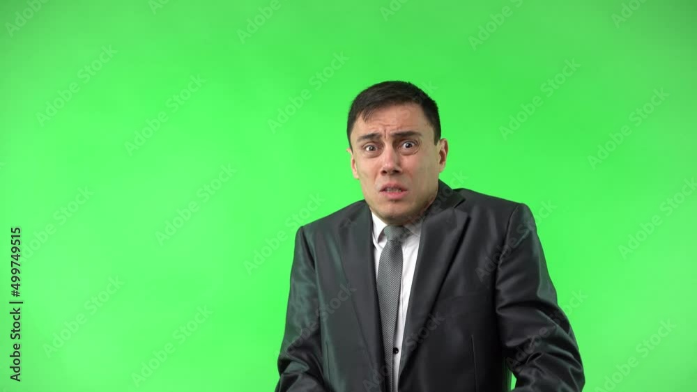 Panicked young man with opened mouth against chroma key Panicked young man with opened mouth against chroma key