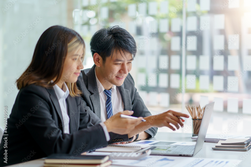 Two Asian business people discuss with new startup project Idea presentation, analyze planning at office. Two Asian business people discuss with new startup project Idea presentation, analyze planning at office.
