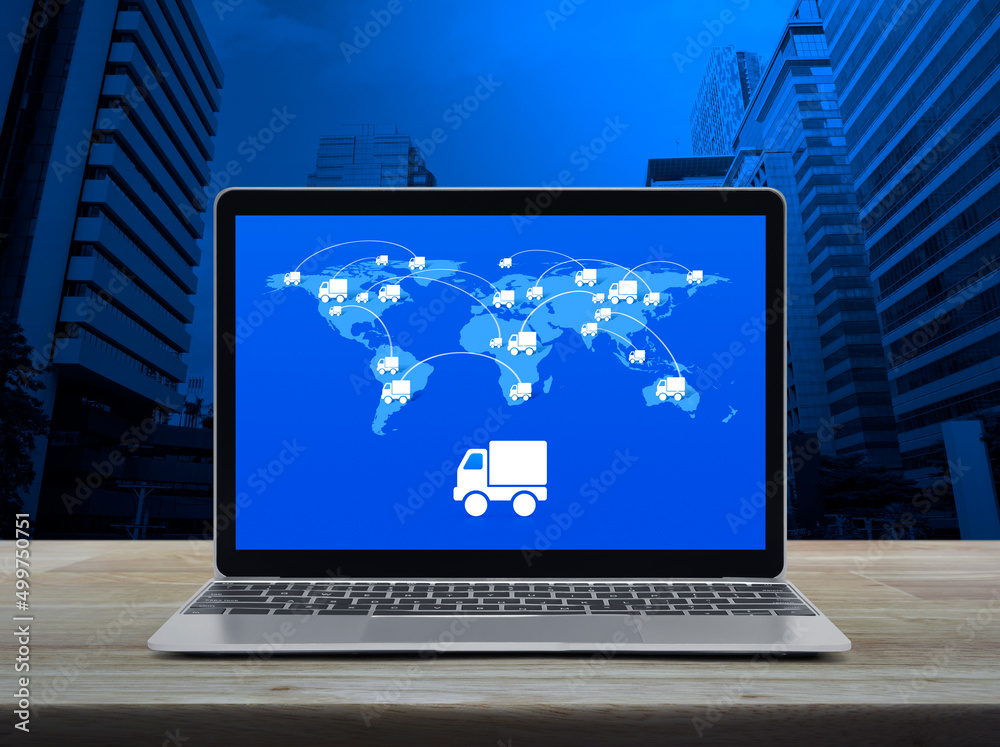 Delivery truck flat icon with connection line and world map on modern laptop computer screen on wooden table over office city tower and skyscraper, Business transportation online concept, Elements of Delivery truck flat icon with connection line and world map on modern laptop computer screen on wooden table over office city tower and skyscraper, Business transportation online concept, Elements of