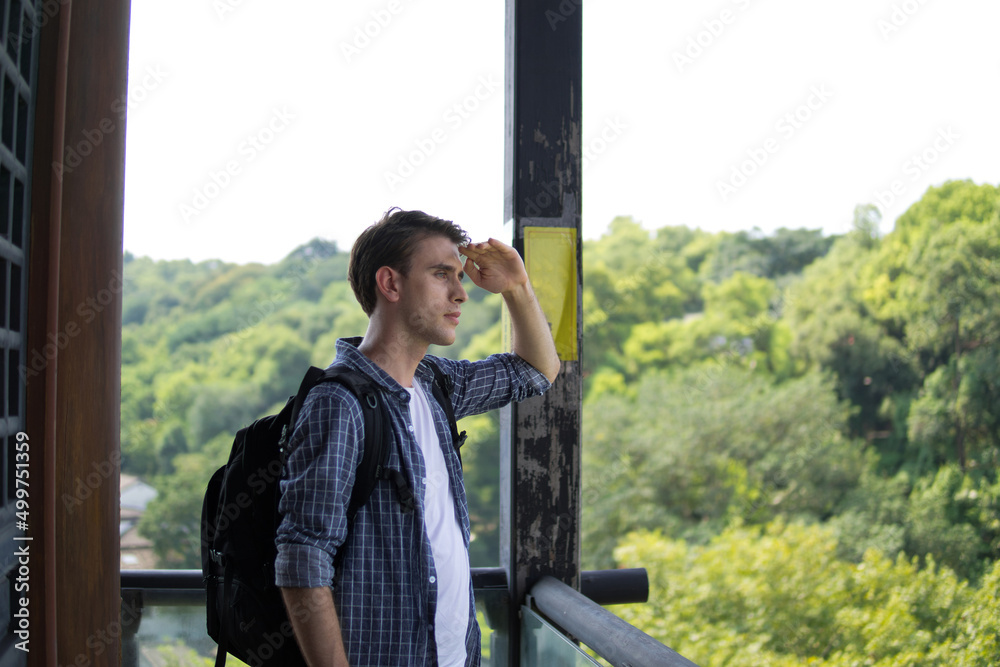 Freedom traveler man with backpack standing on observatory deck and enjoying beautiful landscape view. Freedom traveler man with backpack standing on observatory deck and enjoying beautiful landscape view.