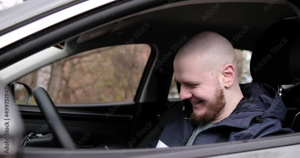 Handsome elegant bearded bald serious man drives a car Handsome elegant bearded bald serious man drives a car