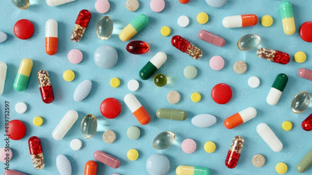 Colorful medical Pills rotating closeup on blue background. Pills, Vitamins and drugs. Pharmaceutical Industry. The medicine concept. Macro shot. Slow motion. High quality 4k footage Colorful medical Pills rotating closeup on blue background. Pills, Vitamins and drugs. Pharmaceutical Industry. The medicine concept. Macro shot. Slow motion. High quality 4k footage