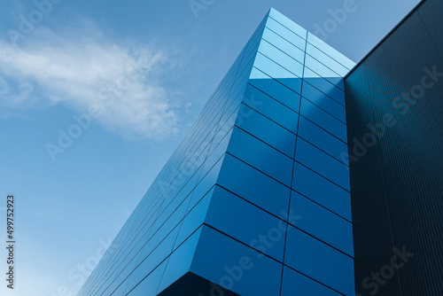 Geometric colored building facade elements with planes  lines and corners with light flare and reflections for an abstract background and texture of white  blue  gray colors. Place for text