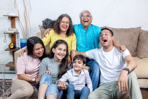 family sitting on sofa and smiling