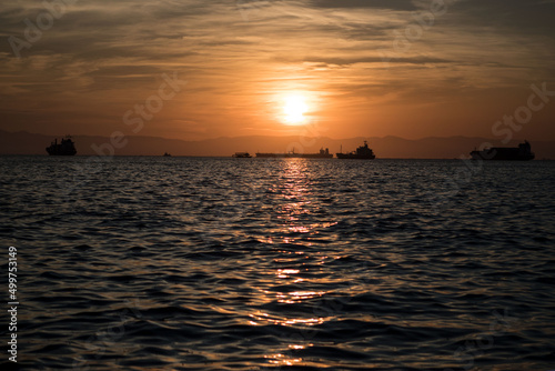 tankers in front of sunset on sea in Thessaloniki in Greece