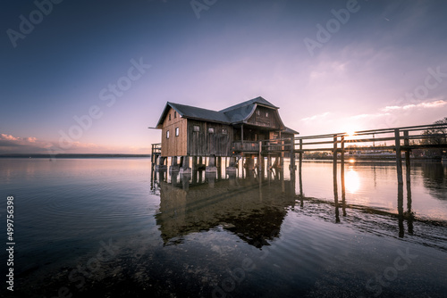 Traditional boathouse at lake Ammersee near Munich, Bavaria, Germany at sunrise. © CreativeImage