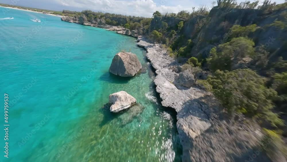 Aerial racing fpv drone view along rocky coast and turquoise sea of Cabo Rojo in Dominican Republic Aerial racing fpv drone view along rocky coast and turquoise sea of Cabo Rojo in Dominican Republic