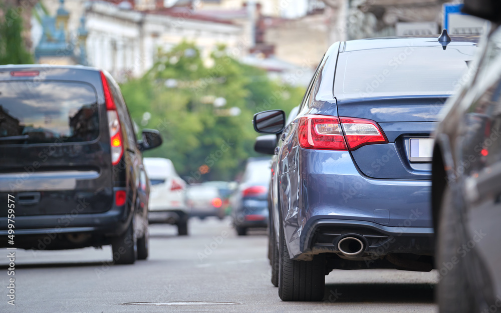 City traffic with cars parked in line on street side City traffic with cars parked in line on street side