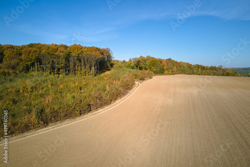 Plowed agricultural field with cultivated fertile soil prepared for planting crops in spring