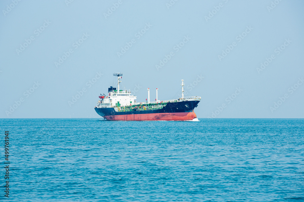Angle side view of oil tanker container ship at sea. Crude oil tanker lpg ngv at industrial estate Thailand - Oil tanker ship to Port of Singapore - import export Angle side view of oil tanker container ship at sea. Crude oil tanker lpg ngv at industrial estate Thailand - Oil tanker ship to Port of Singapore - import export