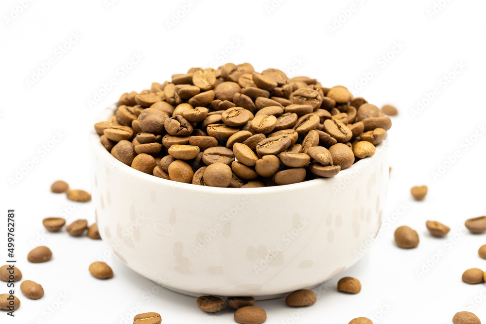Coffee beans isolated on a white background. Full of coffee beans in a marble plate. Close-up. Coffee beans isolated on a white background. Full of coffee beans in a marble plate. Close-up.