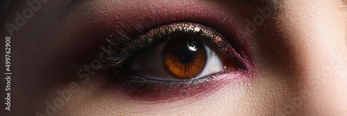 Bright pink professional makeup on eyes of woman closeup