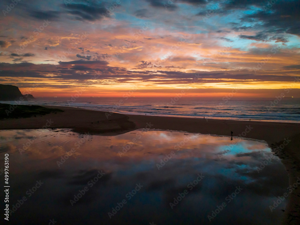 Dawn reflections and clouds at the seaside with lagoon