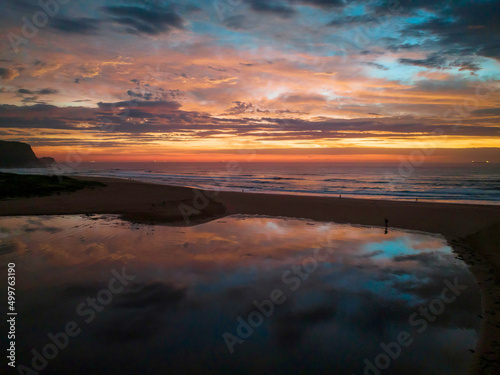 Dawn reflections and clouds at the seaside with lagoon